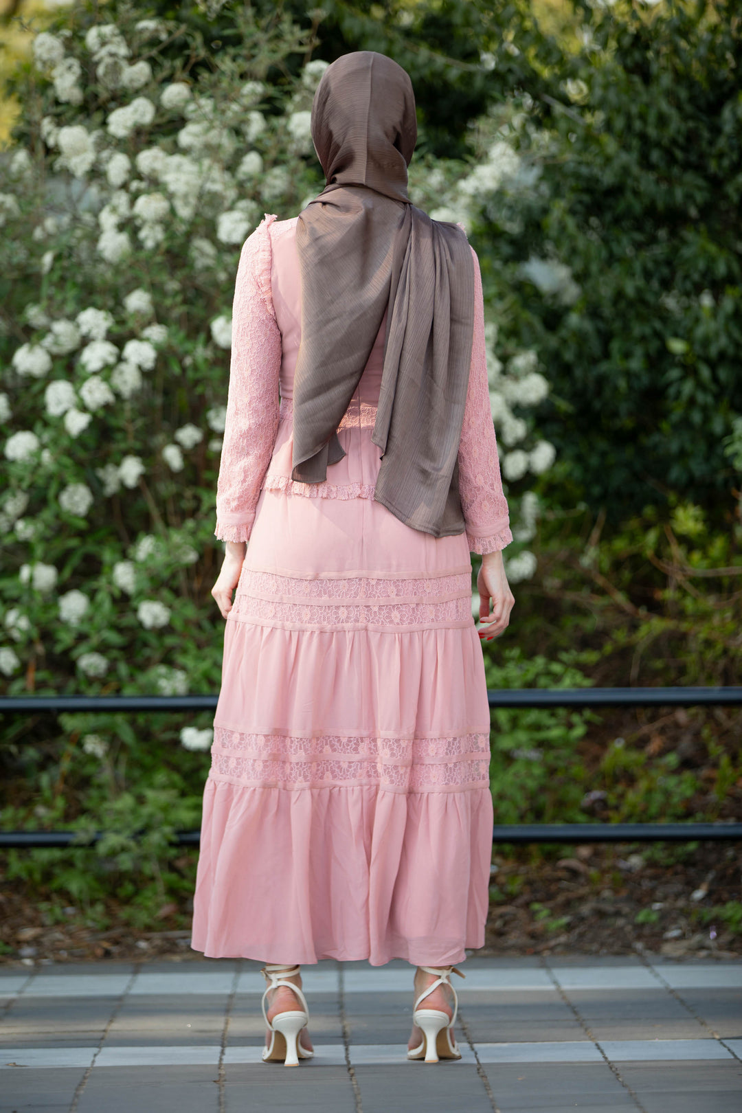 a woman wearing a hijab and a pink dress