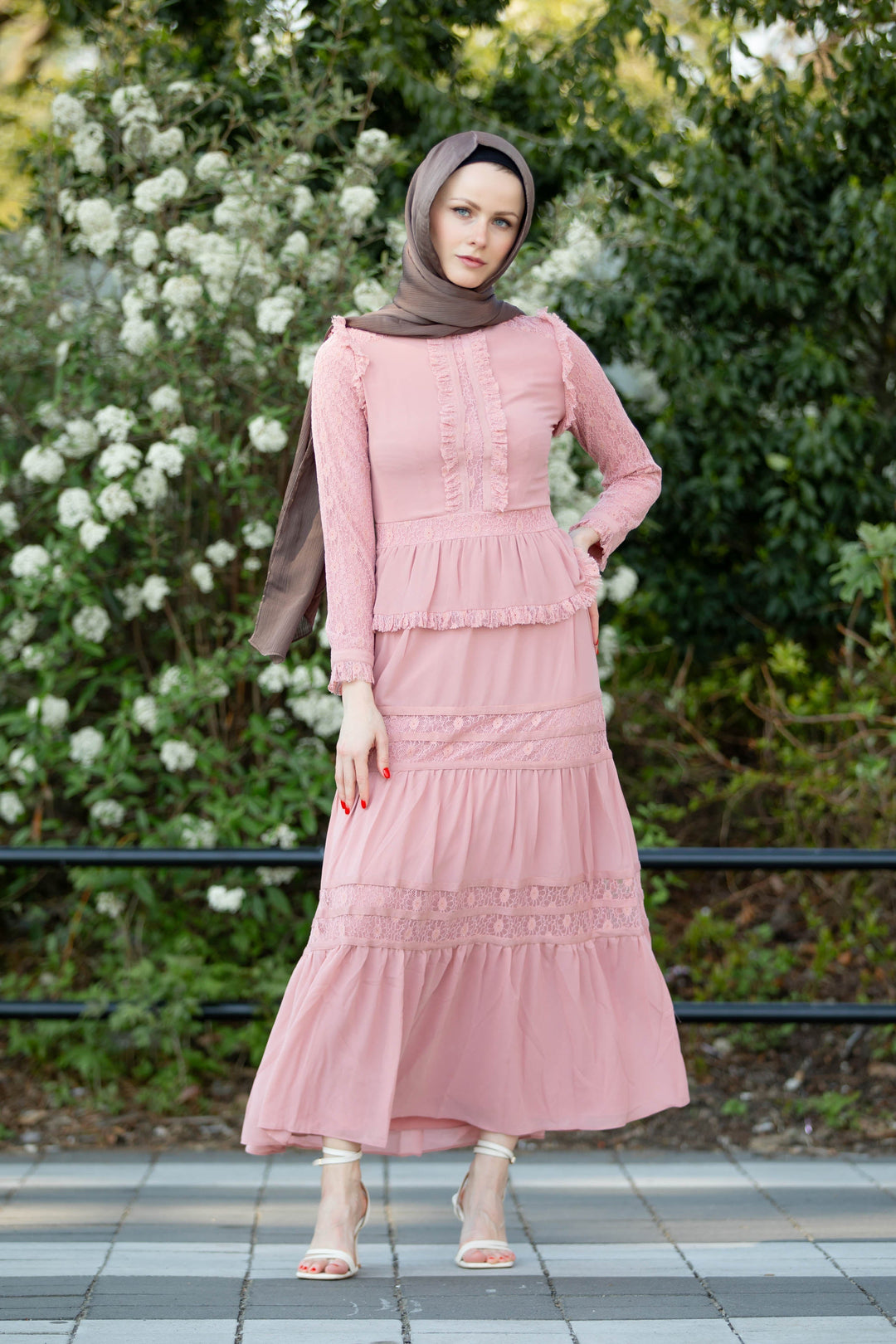 a woman wearing a pink dress and hijab