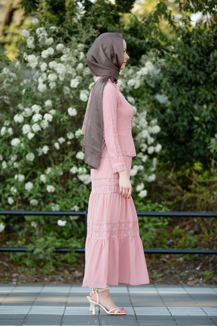 a woman in a pink dress and a hijab