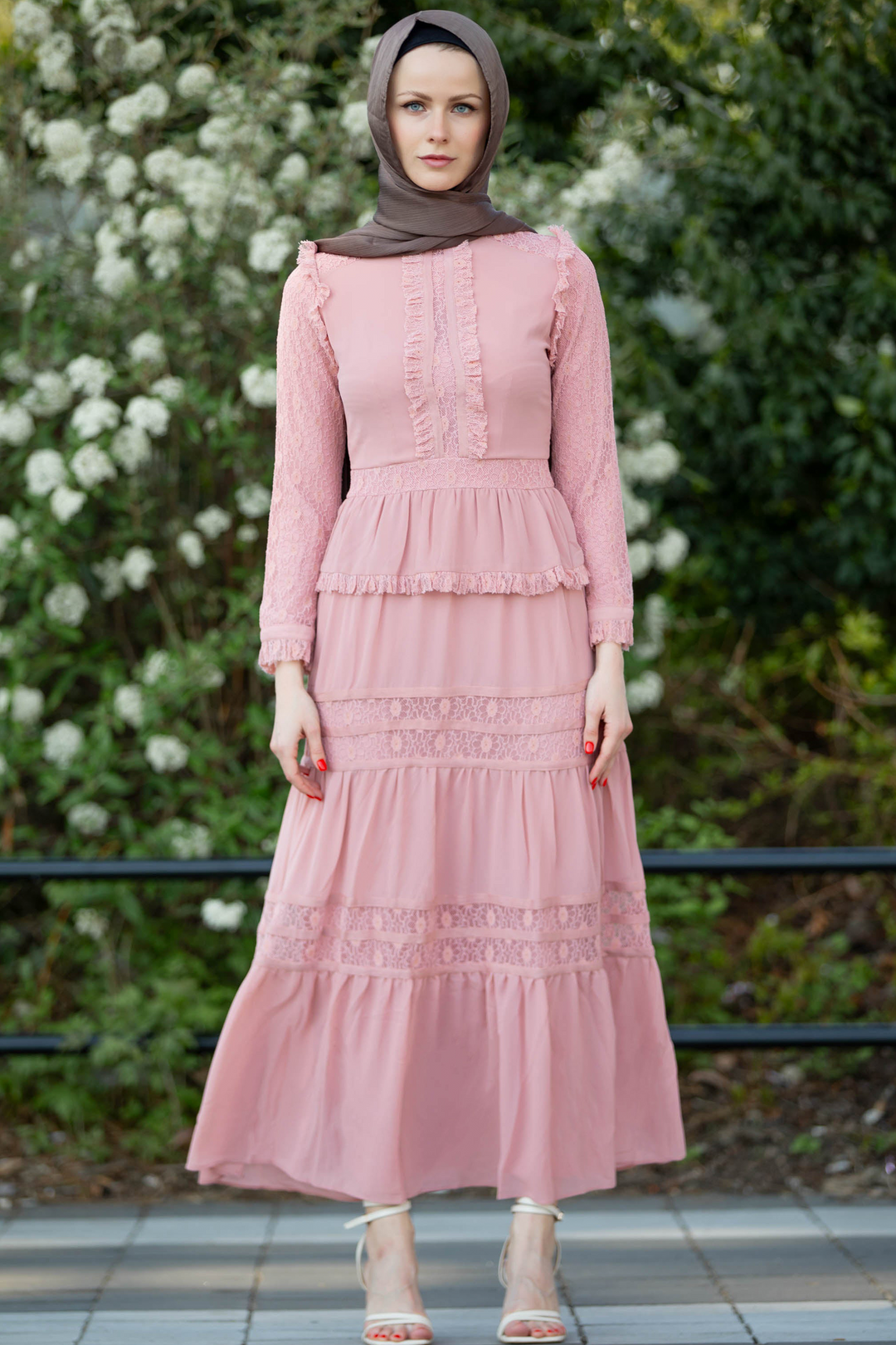 a woman wearing a pink dress and hijab