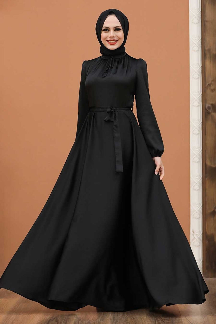 a woman wearing a black dress and a hijab