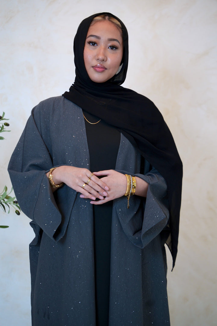 a woman in a black dress and a black shawl