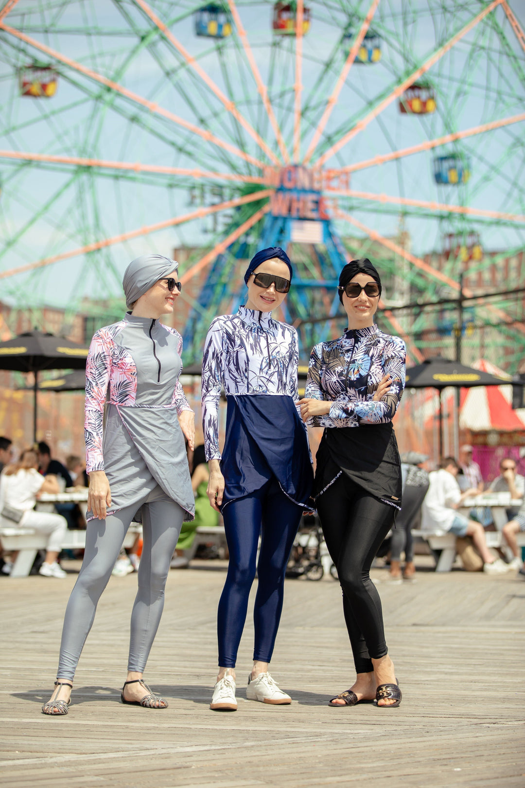 Three women in Navy Floral modest swimsuit showcasing style and comfort