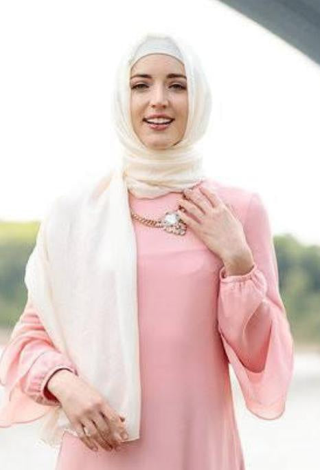 Woman in a hijab and pink dress wearing a White Shimmer Hijab Head Scarf