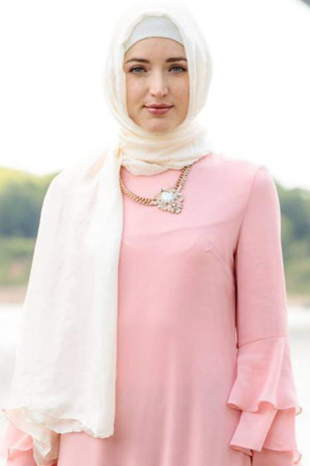 Woman in hijab and pink dress wearing a White Shimmer Hijab Head Scarf