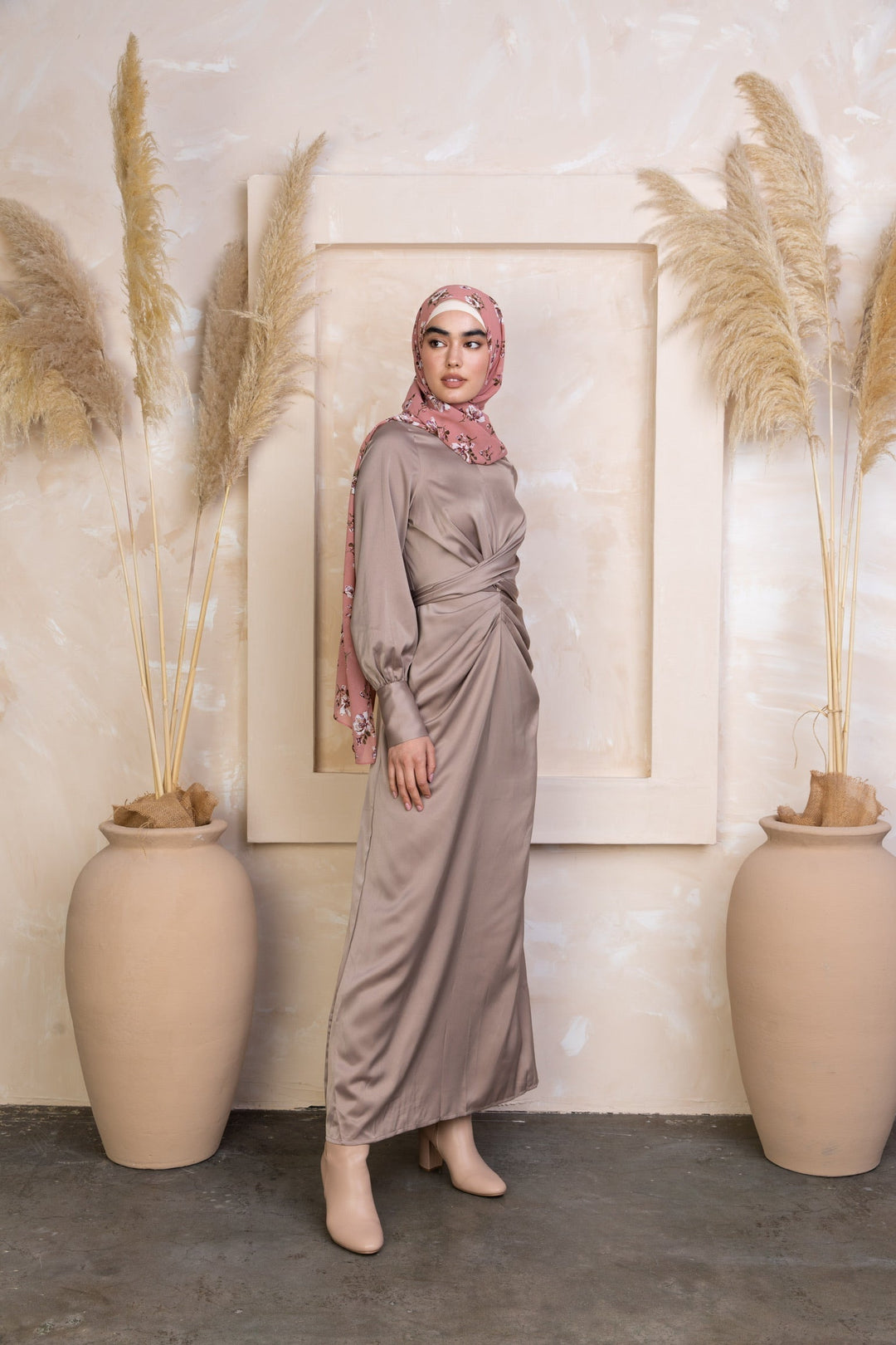 Woman in Zana Criss Cross Satin Maxi Dress with hijab, showcasing elegant draped design